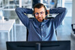 © Valerii Apetroaiei - A call center worker sitting at a laptop in the office.