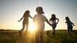 © maxximmm - happy family. people in the park. children child running together in the park on the grass silhouette. daughter and son are running. happy family and little child in summer. concept sunset dream