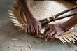 Close up Old man Hand weaving wicker basket or bamboo basketry indoors.Weaving bamboo fish trap in Thailand.closeup view