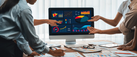 Fototapete - Panorama shot analyst team utilizing BI Fintech to analyze financial report with laptop. Businesspeople analyzing BI power dashboard displayed on laptop screen for business insight. Scrutinize