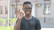 © stockbakers - Outdoor Portrait of Young Man Doing Ok Sign