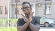 © stockbakers - Outdoor Portrait of Young African Man in Denial, Stop Gesture