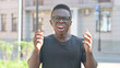 © stockbakers - Outdoor Portrait of Upset Young African Man Shocked by Loss