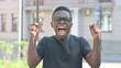 © stockbakers - Outdoor Portrait of Excited Young African Man Celebrating Success