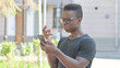 © stockbakers - Outdoor Portrait of Upset African American Man get Shocked on Smartphone