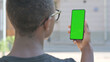 © stockbakers - African Man using Phone with Green Screen Outdoor