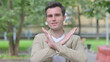 © stockbakers - Outdoor Portrait of Casual Young Man in Denial, Stop Gesture