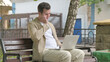 © stockbakers - Young Man with Headache Working on Laptop Outdoor