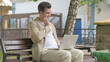 © stockbakers - Young Man with Toothache Working on Laptop Outdoor