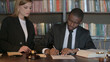 © stockbakers - Team of Lawyers Signing Legal Documents in Office