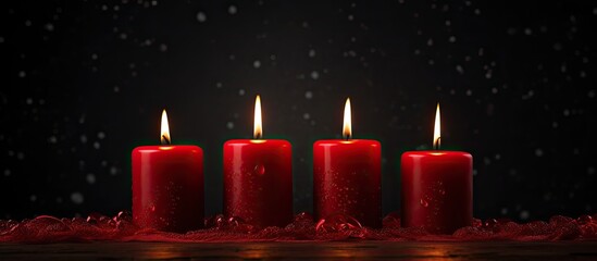 Leinwandbilder - Four red candles displayed against a dark background, with ample space for a banner, panorama,