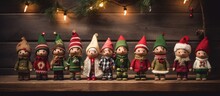 Christmas Elves Clothing And Dolls Arranged On A Wooden Background. Empty Space Around Them