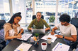 © Valerii Apetroaiei - A group of young freelancers working in a coworking space
