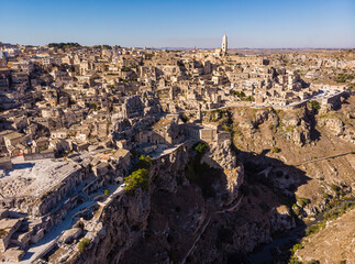 Canvas Print - Aerial view of medieval city of Matera Sassi di Matera in beautiful golden morning light at sunrise. Birds view of Sassi di Matera, in Basilicata, southern Italy