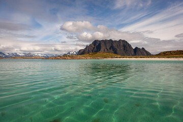 Poster - a body of water in the ocean, with mountains in the distance