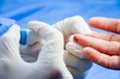 © Tamar Dundua/Wirestock Creators - Close-up of a medical professional taking a blood sample from a patient's finger