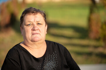 Belarus, a village near the city. October 22, 2021. Photographing ordinary elderly people. Close-up portrait of an elderly very plump woman with a short haircut.