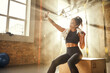 © Friends Stock - Taking photo after workout. Happy attractive athletic woman in headphones wearing towel on her shoulders and making selfie while sitting at gym