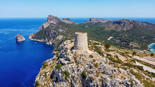 Aerial View Of The Albercutx Watchtower, An Ancient Fortified Building Sitting At The Top Of A Mountain Of Cape Formentor On The Northeastern Coast Of Mallorca In The Balearic Islands, Spain