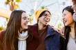 © Xavier Lorenzo - Group of young happy friends enjoying winter vacation outdoors. Millennial student people laughing and having fun in city street.