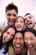 © CarlosBarquero - Vertical portrait multiracial friends excited outdoors. Group diverse young people funny expression posing together selfie photo. Happy people enjoying friendship in community. Social relationships.
