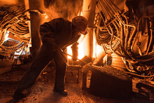 Steelworker At Work Near The Arc Furnace