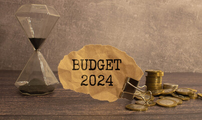 Budget 2024 written on blackboard with someone is holding it