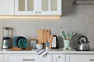 Wall Mural - Set of different utensils and dishes on countertop in kitchen