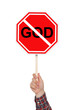 © New Africa - Atheism concept. Man holding prohibition sign with crossed out word God on white background
