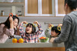 © imtmphoto - young asian family with two children having a good time in kitchen at home