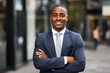 © STORYTELLER - Confident African smiling businessman portrait with folded hand