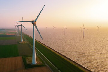 offshore windmill park with clouds at sunset, windmill park in the ocean aerial view with wind turbine Flevoland Netherlands Ijsselmeer. Green energy 