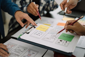 Creative male web designer planning application development for web mobile phone at modern workplace.