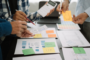 Creative male web designer planning application development for web mobile phone at modern workplace.
