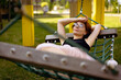 © Cavan Images - Woman chilling in a hammock, summer atmosphere.