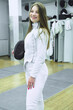 Girl in white sport wear with a sword on training. Fencing exercises