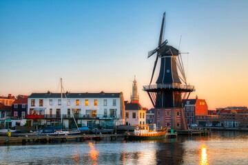 Wall Mural - The Binnen Spaarne Canal Running through Haarlem, the Netherlands, with the Famous Windmill De Adriaan, in the Afternoon Sun