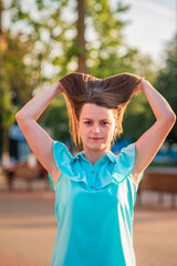 Wall Mural - Portrait of a young beautiful girl in a summer park.