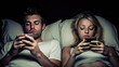 © Sasint - Couple sleeping with smartphones in their bed. Mobile phone addiction. Bored distant couple ignoring each other lying in bed at night while using mobile phones.