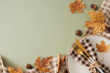 Fall-themed table setup concept.Top view photo of plate, cutlery, checkered napkin, tablecloth, cinnamon sticks, anise, acorns, maple leaves on olive background with empty space for promo or text