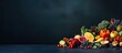 Vegan ingredients such as autumn vegetables, berries, and mushrooms from a local market are placed on a dark blue background with copy space.