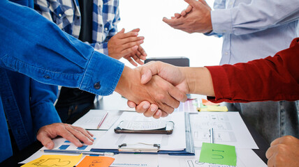Close-up ux developers and ui designers use augmented reality to brainstorm on mobile app interface wireframe designs on modern office desks. Creative digital development office