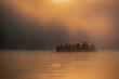 Wschód słońca nad rzeką Odrą po której płynie barka