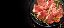 Top View Of Italian Prosciutto Cotto With Pork Ham Slices On A Black Background, Ready To Be Served. Copy Space Available.