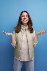 Wall Mural - positive cheerful black-haired young lady in casual clothes over isolated background