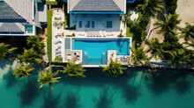 Top View Of Beach House With Palm Trees And Pool