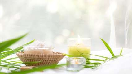 Wall Mural - Thai Spa Treatments aroma therapy salt and  sugar scrub massage with bamboo leaves with candle, white background. Thailand. Healthy Concept