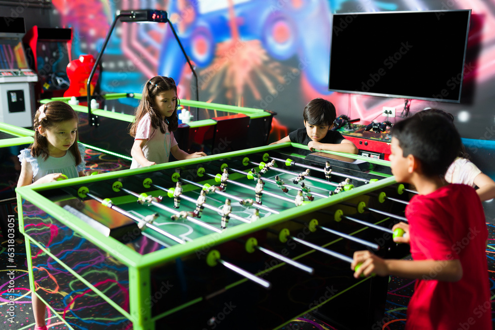 Cheerful kids having an arcade competition and laughing Stock Photo ...