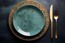 Green And Blue Colors Plate With Golden Fork Spoon And Knife