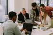 © qunica.com - Multiracial business team working on a same project